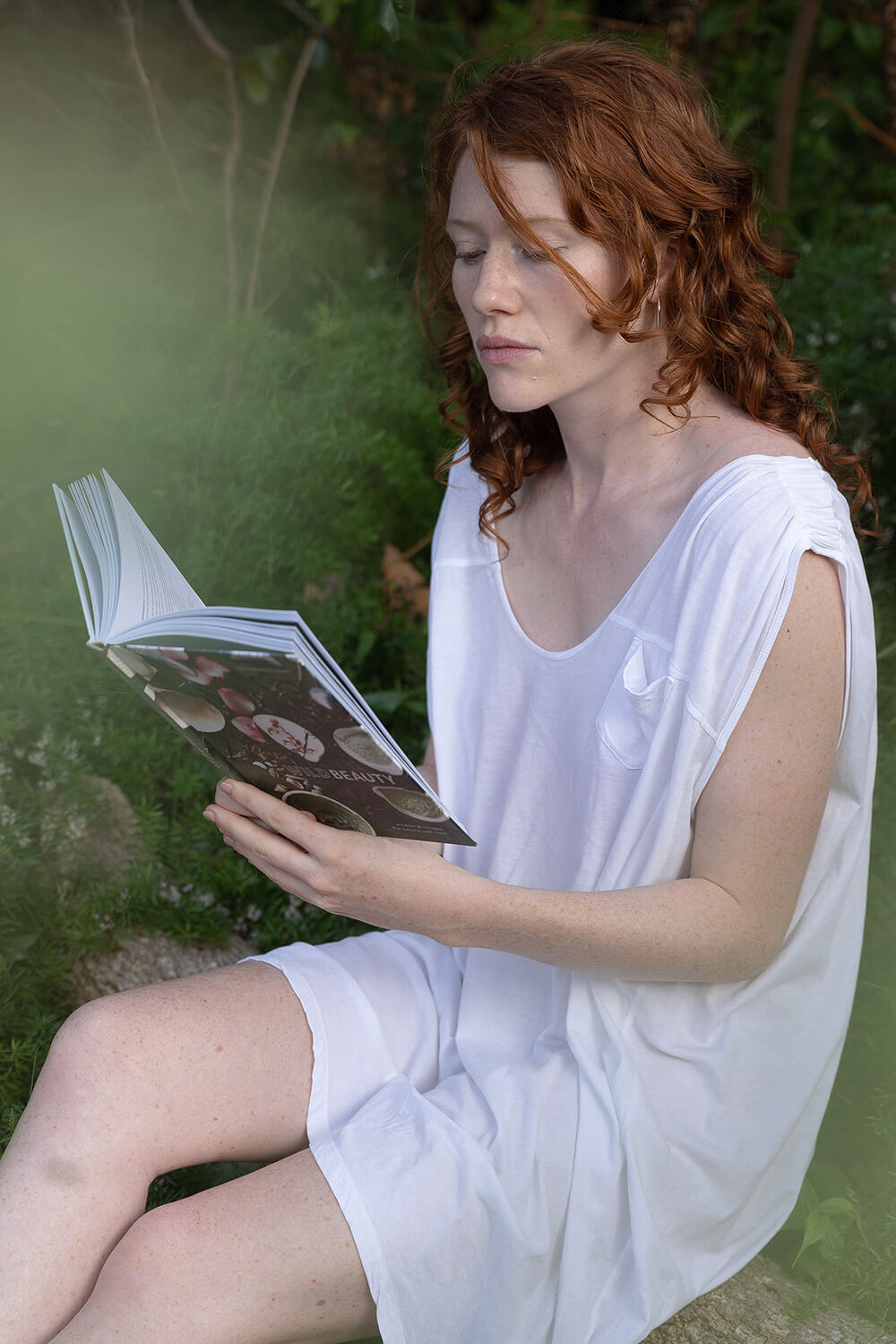 Woman reading in nature Wild Beauty DIY Beauty Recipes by Jana Blankenship